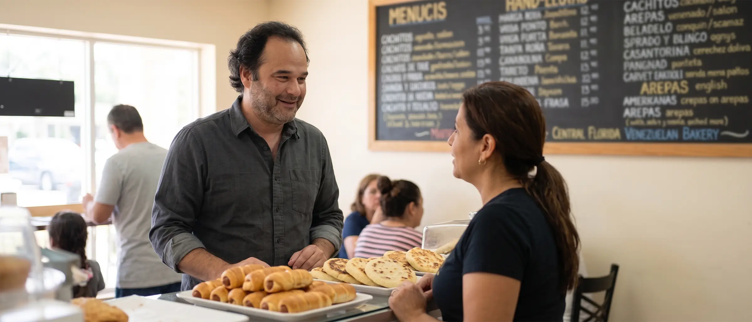 Hispanic Market SEO — Spanish & Portuguese SEO Services, Orlando FL Jose Barrios, an Orlando SEO consultant, talking with a Hispanic small business owner inside her shop